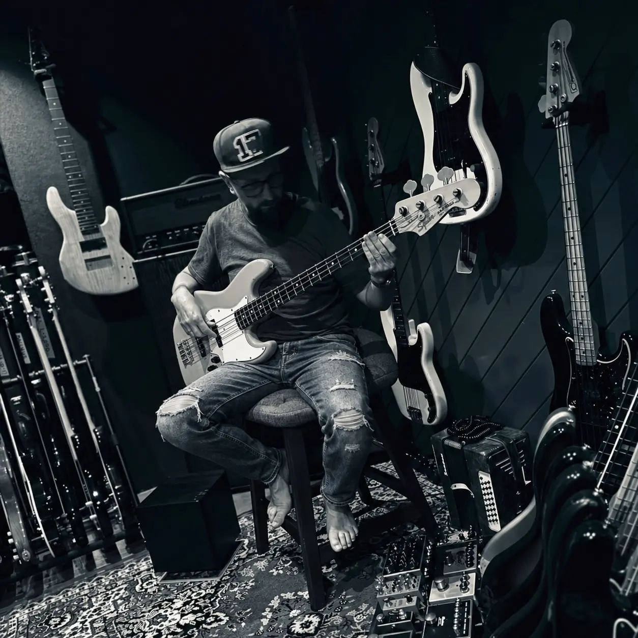 Kenno sitting and playing bass in The Chamber
