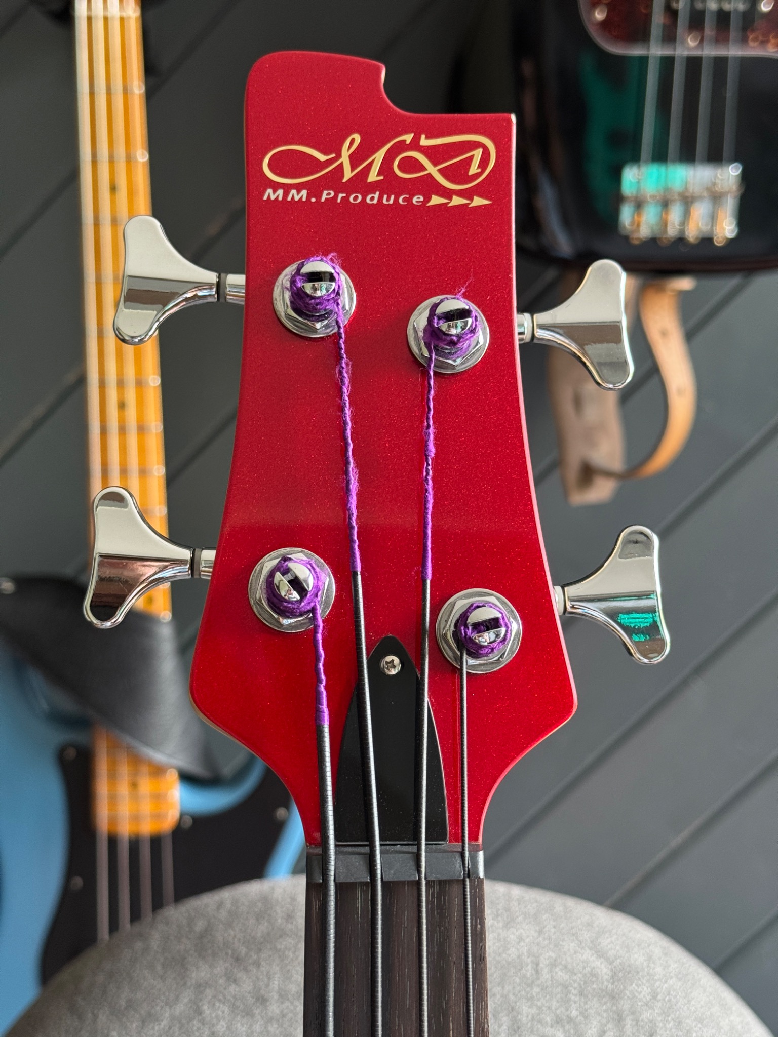Front of the headstock with MD-MM Produce logo and tuners