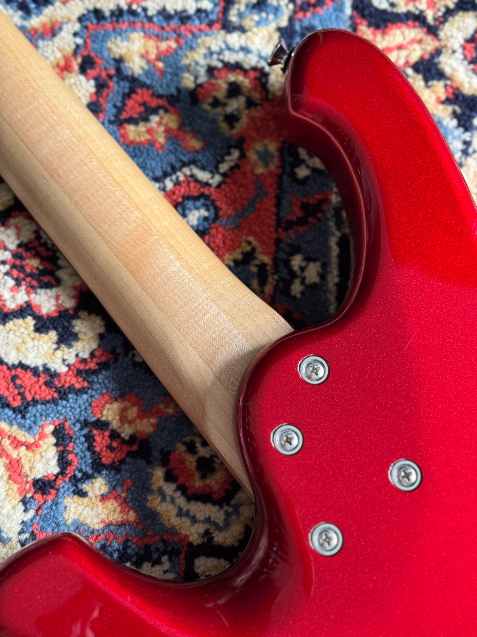 Back of the red body with the neck and mounting screws