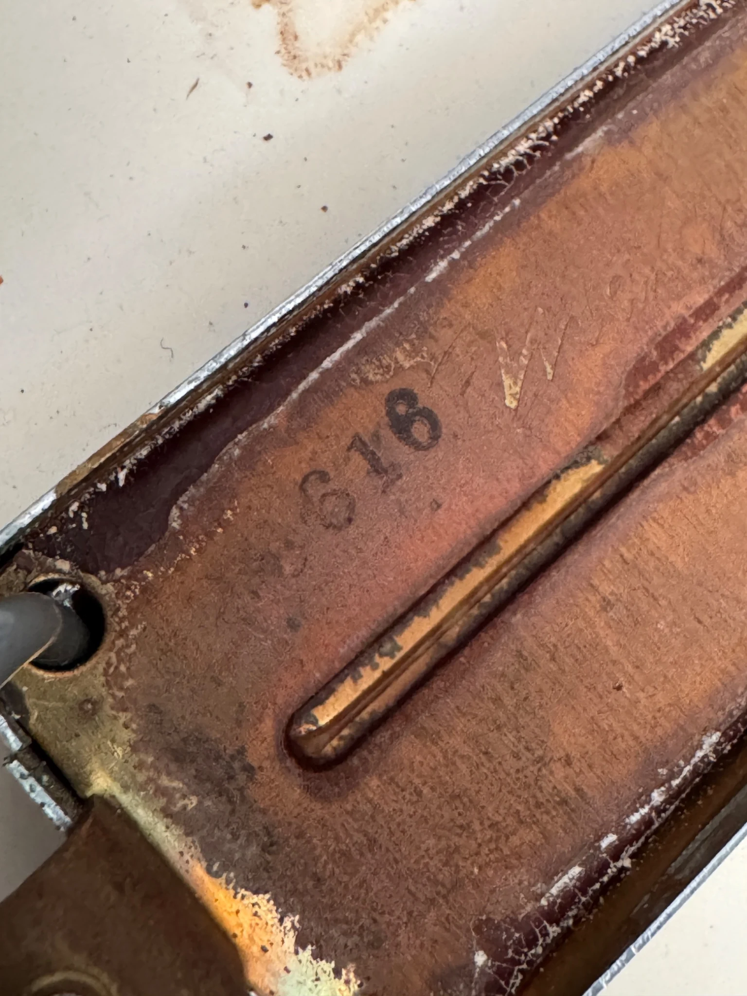 Close-up of worn markings on a bass bridge